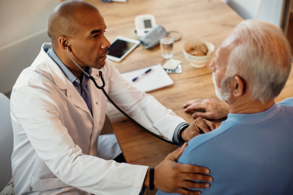 Black doctor examining a senior patient during a Medicare health checkup in Austin Texas